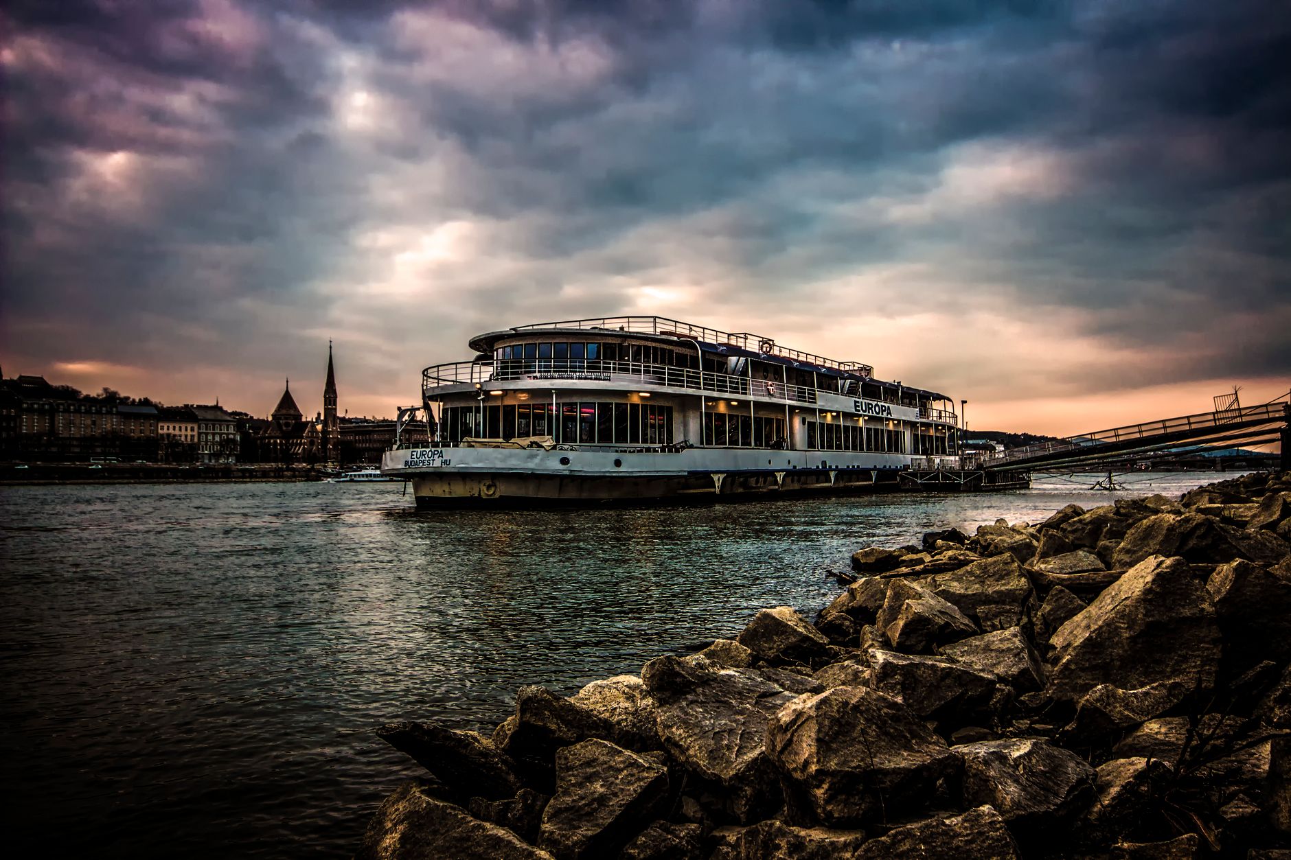 Viking river cruise ship illuminated in historic European city at night